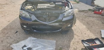 6 999 р. Передний бампер TYG (без отверстий под омыватели, 1.6L/2.0L) Mazda 3/Axela BK дорестайлинг седан (2003-2006) (Неокрашенный)  с доставкой в г. Белгород. Увеличить фотографию 2